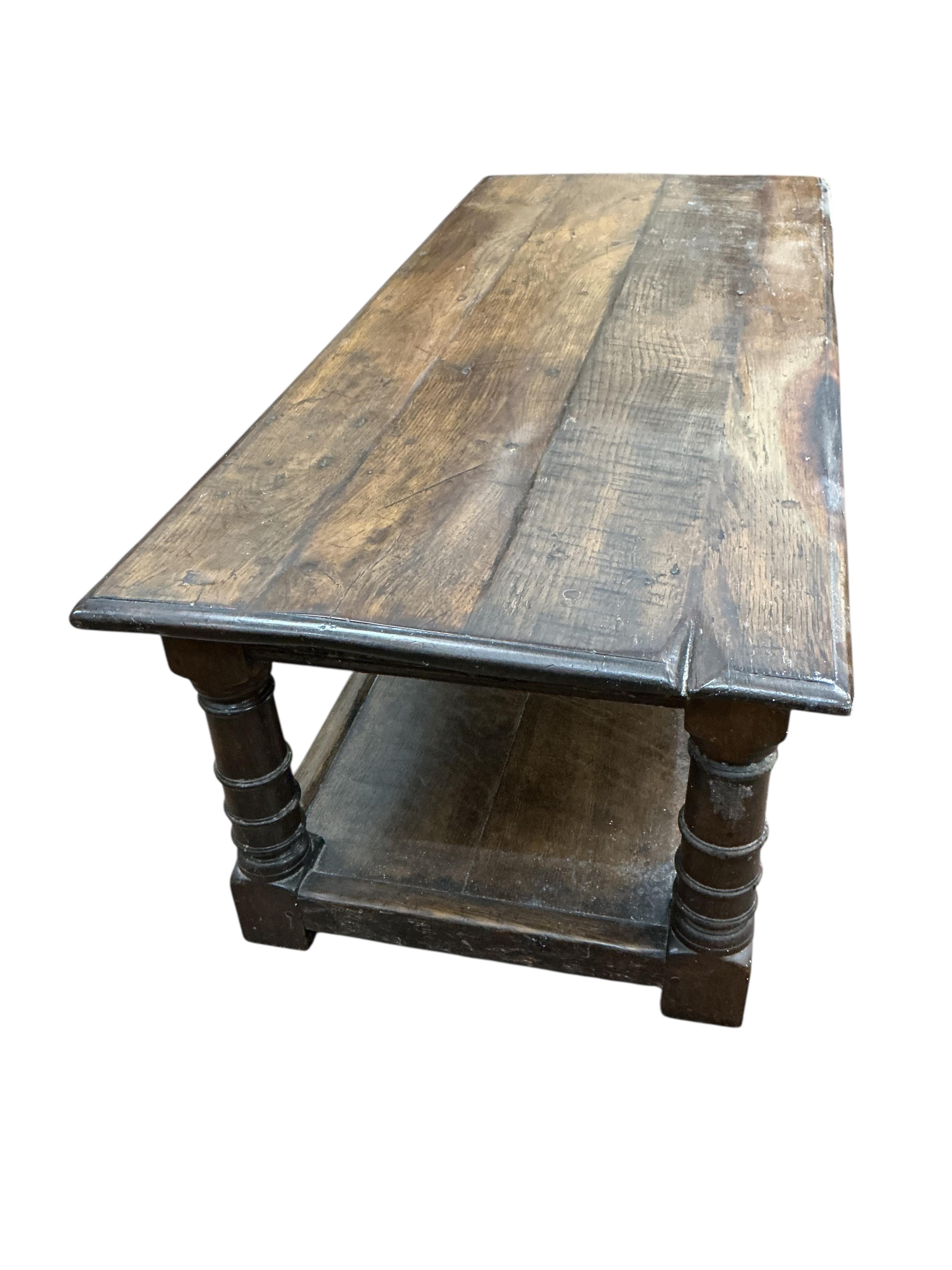 An 18th century style rectangular oak two tier coffee table, width 122cm, depth 50cm, height 43cm